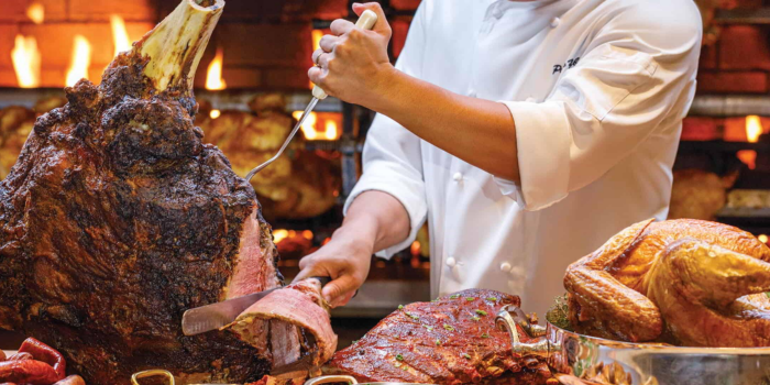 This is a picture of a chef serving meat from a carving station in the Buffet at the Bellagio Las Vegas