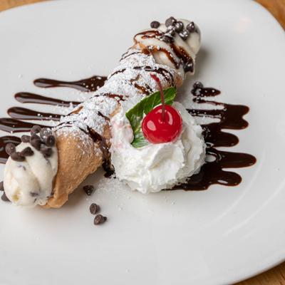 A plate of delicious Cannoli dessert at Casa di Amore