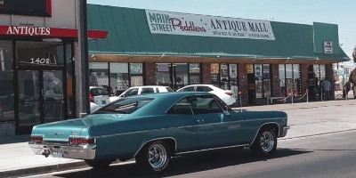 This is a frontage picture of the Main Street Peddlers Antique Store in Las Vegas with a classic car driving by