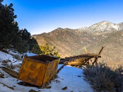 A view of a rusty mining cart and rail system at the Panamint City Ghost Town