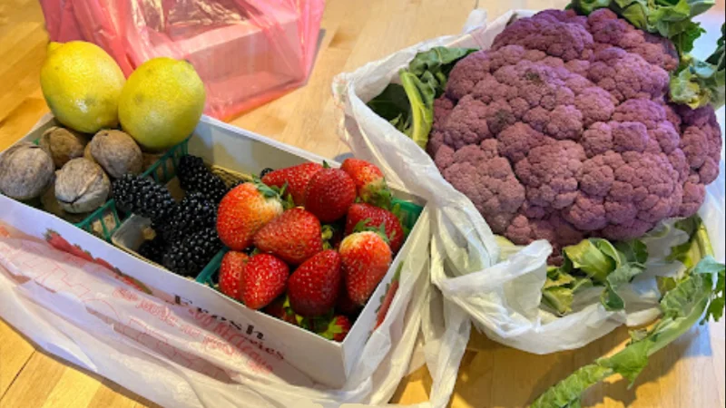 These are fresh berries and a purple cauliflower at the Sun City Anthem Farmers Market