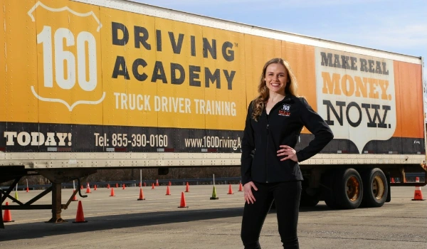 160 Driving Academy of Las Vegas a new student stands in front of a semi truck