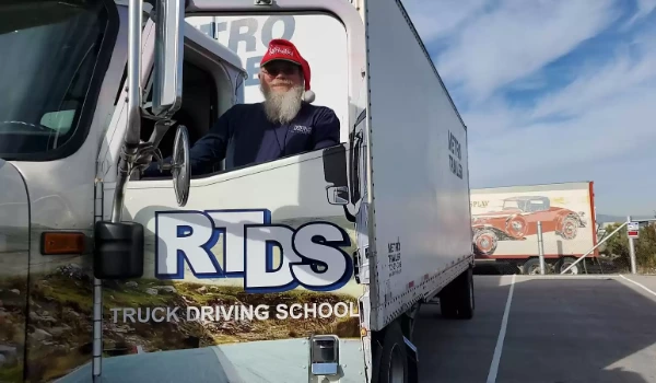 RTDS Trucking School picture of a big rig and its driver