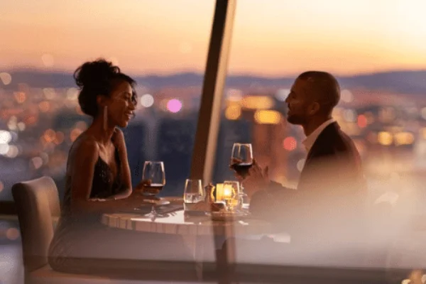 The STRAT Top of the World Restaurant - a couple of people dine in the dusk light