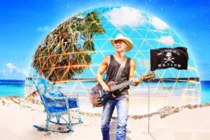 Kenny Chesney performing at the Sphere Las Vegas with an image of him on the beach